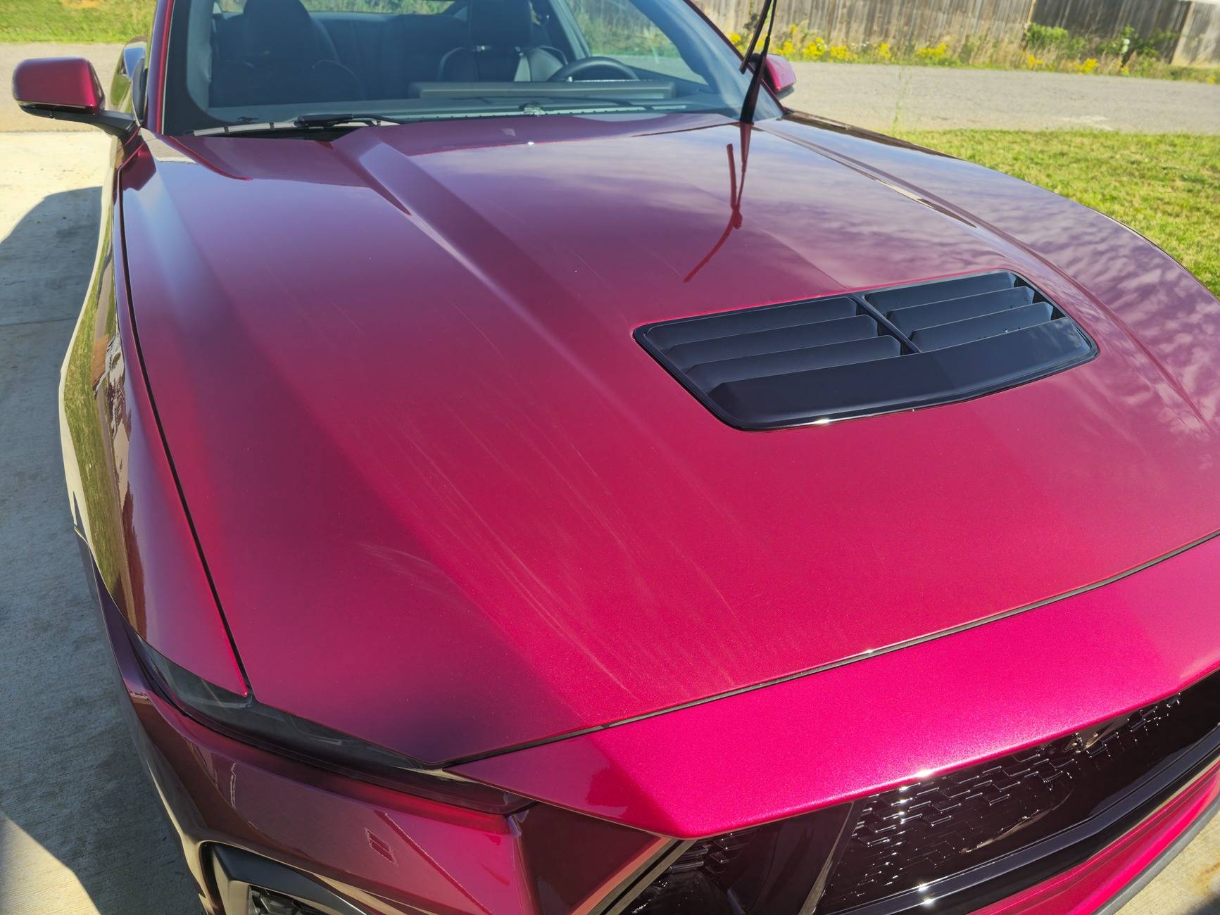 S650 Mustang Dealer attempted to fix some paint defects on the hood of our new S650 but now there appears to be streaks in the clear coat. What caused this? 20250518_092649