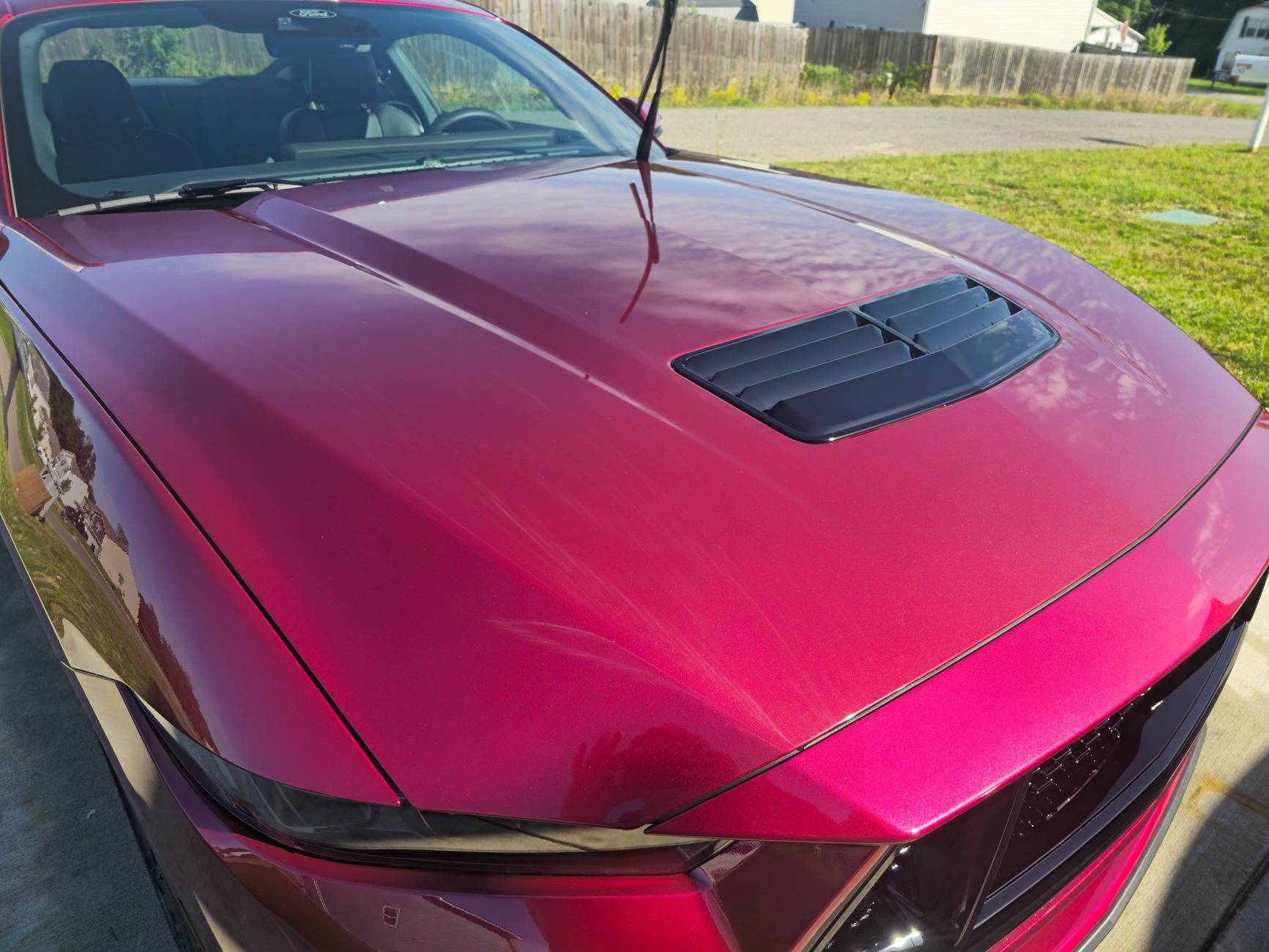 S650 Mustang Dealer attempted to fix some paint defects on the hood of our new S650 but now there appears to be streaks in the clear coat. What caused this? 20250518_092652