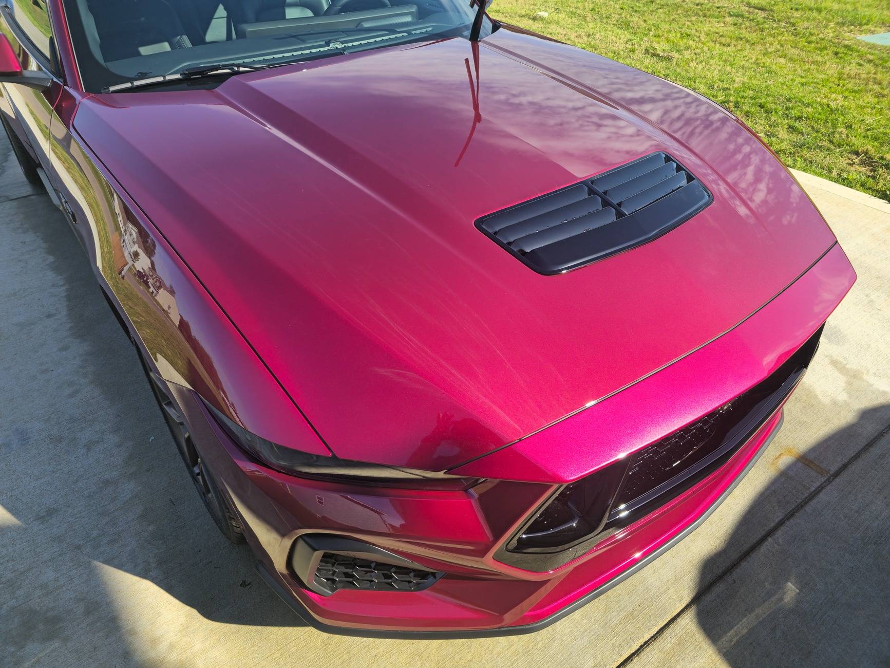S650 Mustang Dealer attempted to fix some paint defects on the hood of our new S650 but now there appears to be streaks in the clear coat. What caused this? 20250518_092656