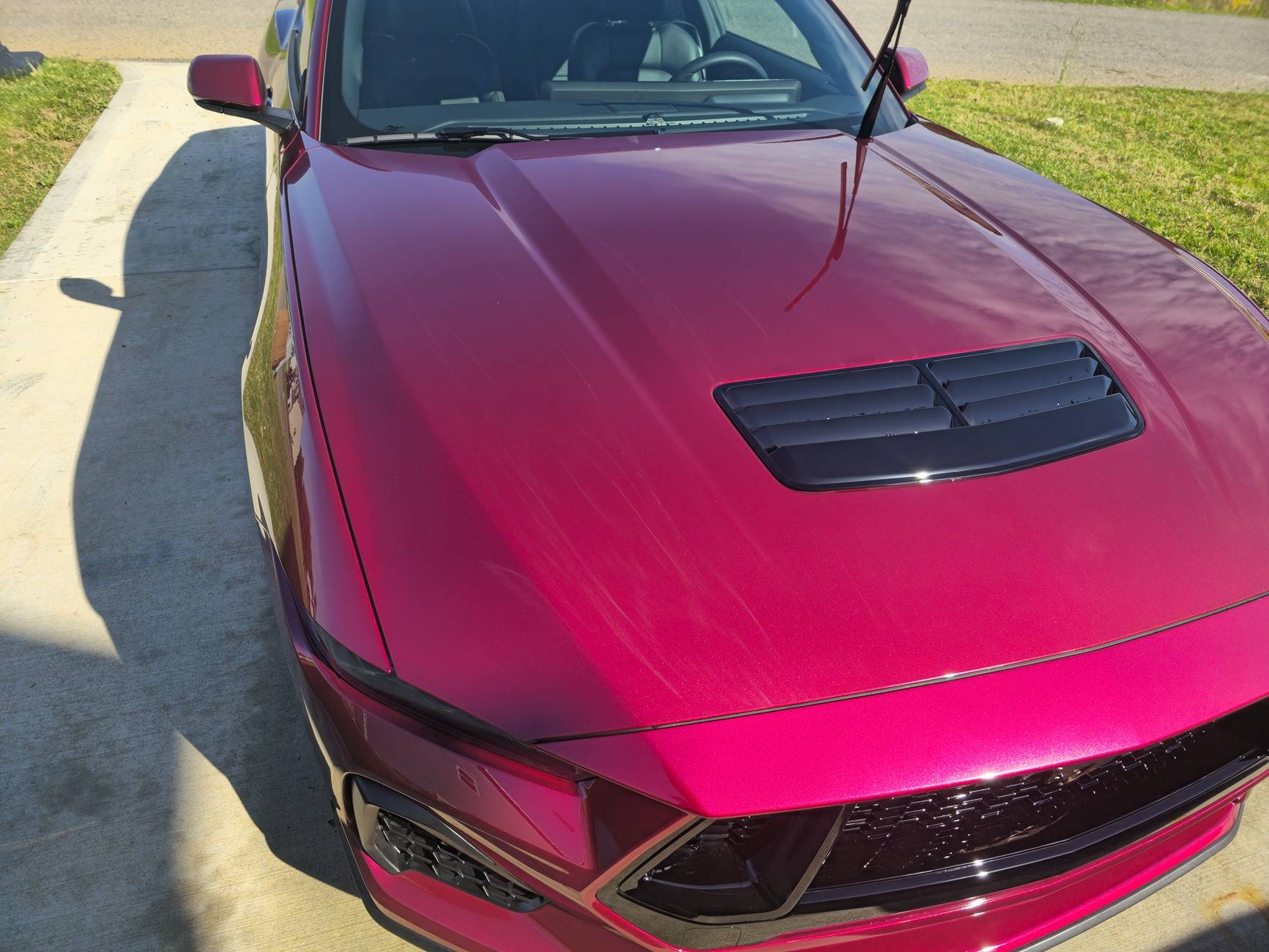 S650 Mustang Dealer attempted to fix some paint defects on the hood of our new S650 but now there appears to be streaks in the clear coat. What caused this? 20250518_092659