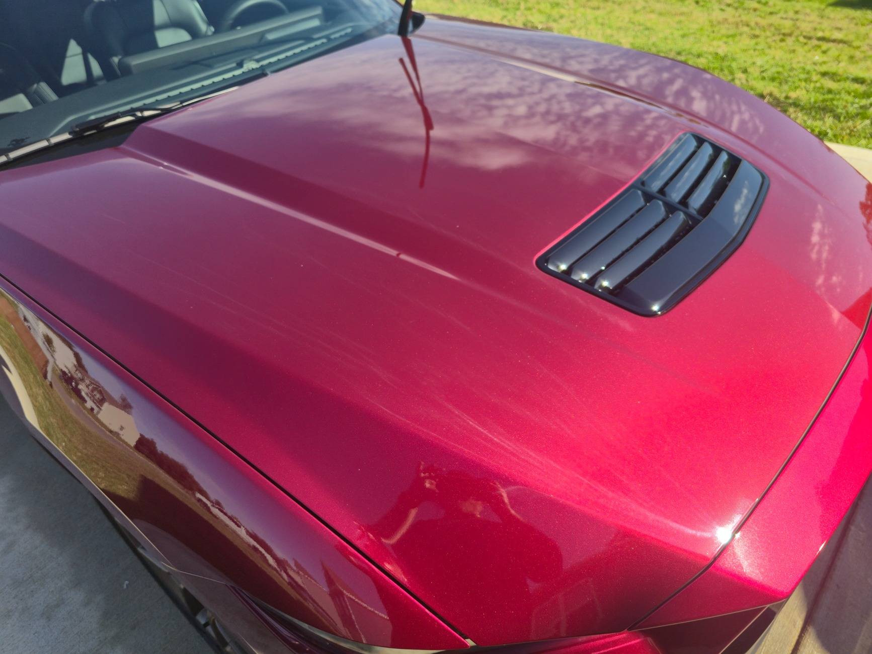 S650 Mustang Dealer attempted to fix some paint defects on the hood of our new S650 but now there appears to be streaks in the clear coat. What caused this? 20250518_092702