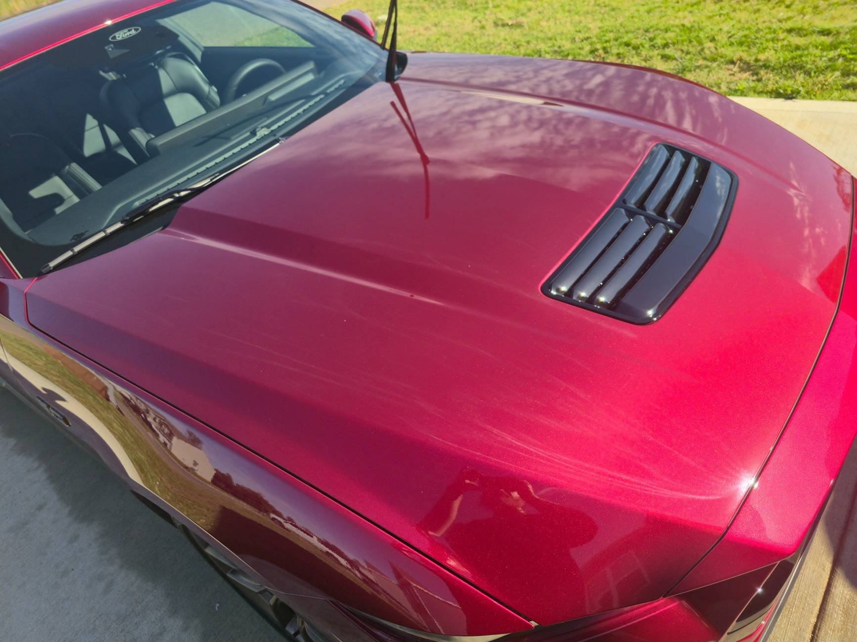 S650 Mustang Dealer attempted to fix some paint defects on the hood of our new S650 but now there appears to be streaks in the clear coat. What caused this? 20250518_092705