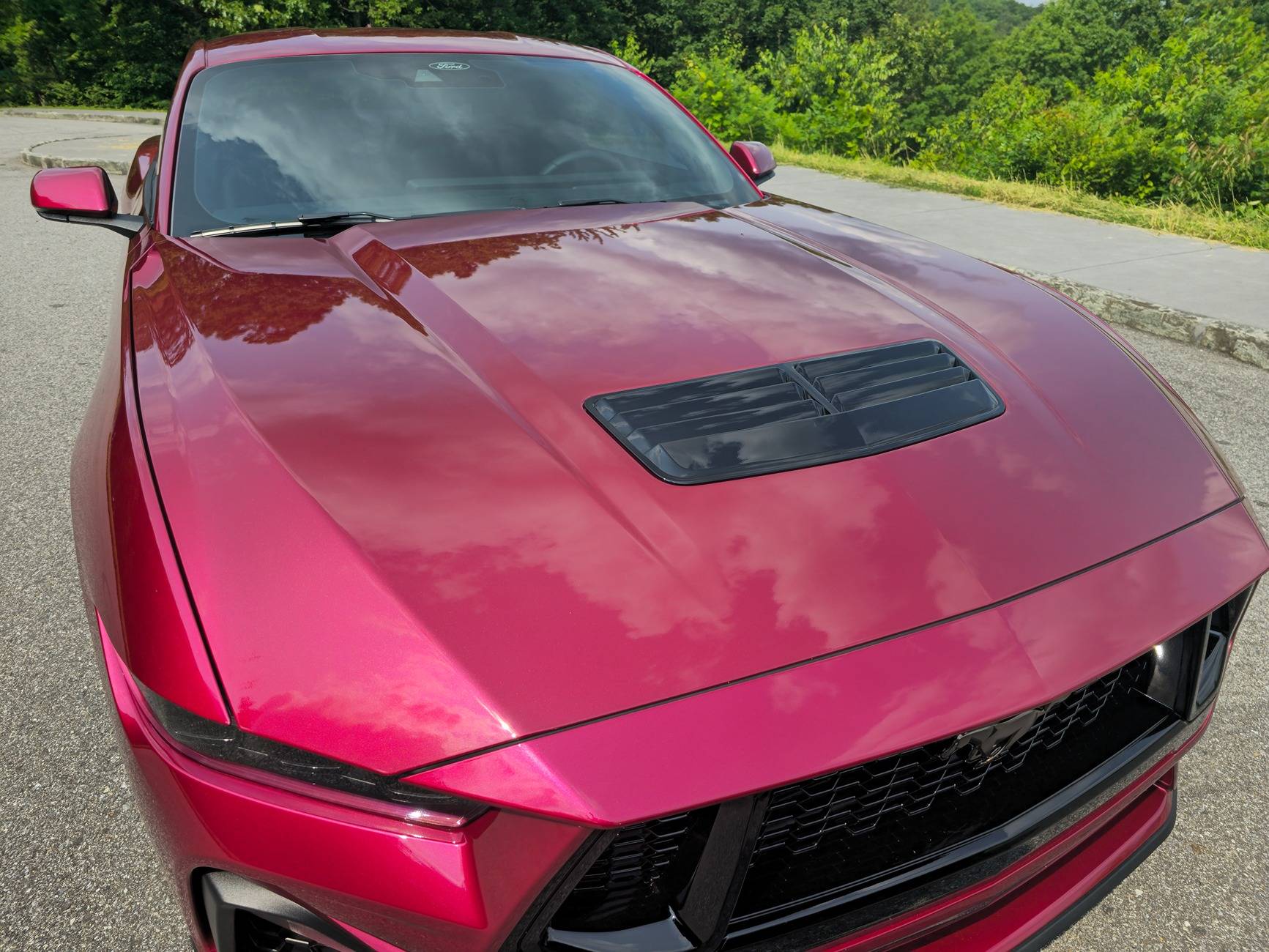 S650 Mustang Dealer attempted to fix some paint defects on the hood of our new S650 but now there appears to be streaks in the clear coat. What caused this? 20250531_161353
