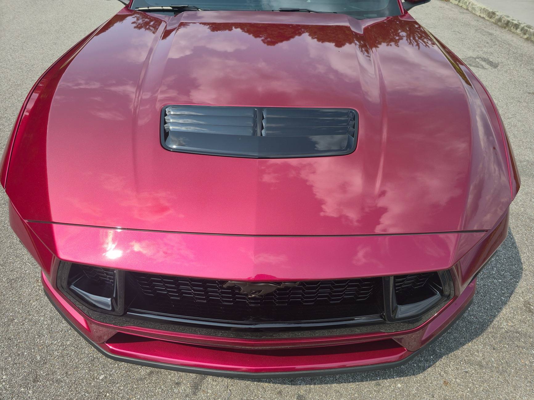 S650 Mustang Dealer attempted to fix some paint defects on the hood of our new S650 but now there appears to be streaks in the clear coat. What caused this? 20250531_161358