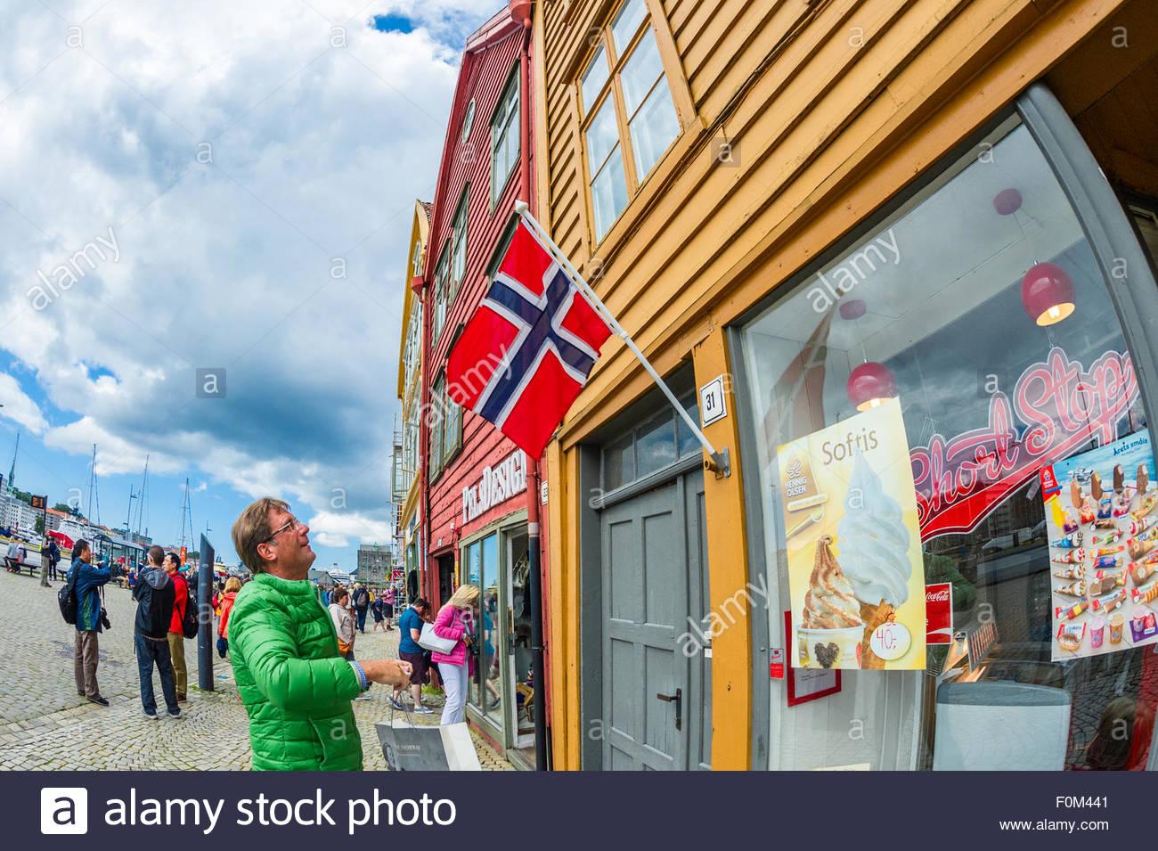 S650 Mustang “Next Gen” Mustang Will be Electric (EV) Only Claims Autoline man-looking-at-the-norwegian-flag-outside-an-ice-cream-shop-in-the-F0M441